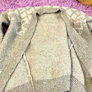 A girl's cozy sweater for winter has doom and pattern